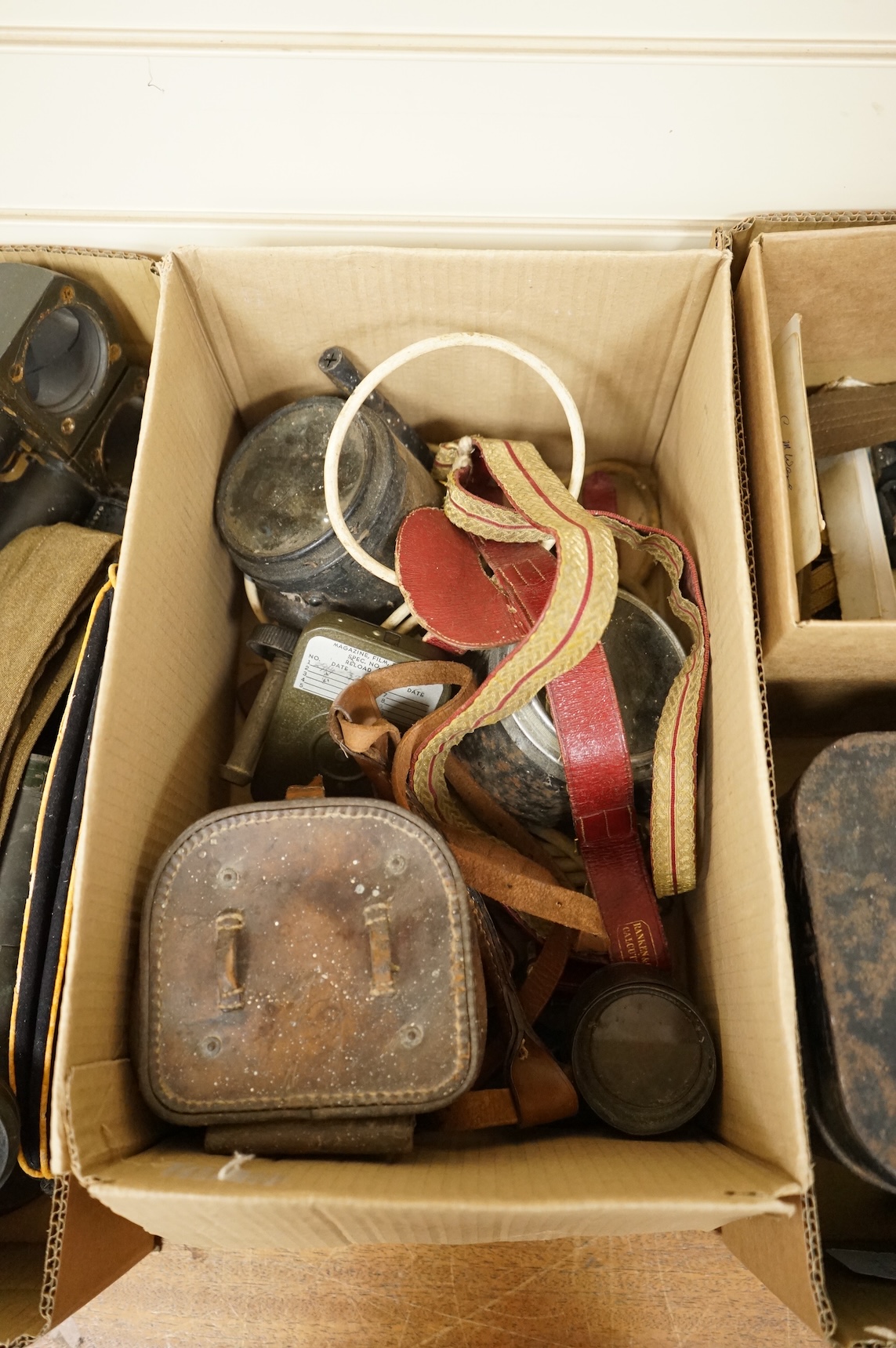 A collection of militaria including; a US Air Force camera Type N-6, a leather cased Bell & Howell Sportster camera and accessories, a pair of periscope binoculars, a leather cased compass by Goerz, Berlin
